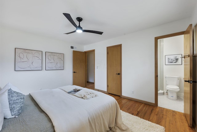 bedroom featuring ceiling fan, connected bathroom, light wood-style flooring, visible vents, and baseboards