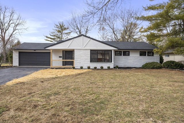 ranch-style house with a front yard, stone siding, driveway, and an attached garage