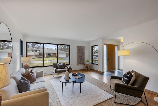 living area featuring baseboards and wood finished floors