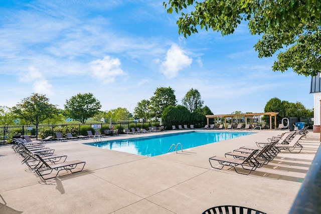 pool with a patio area, fence, and a pergola