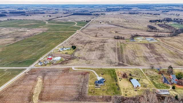 birds eye view of property with a rural view
