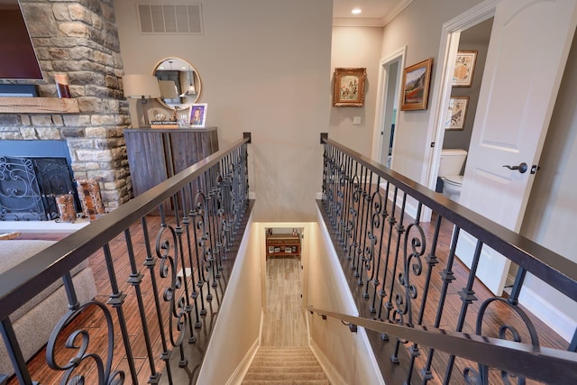 hallway featuring ornamental molding, an upstairs landing, visible vents, and recessed lighting