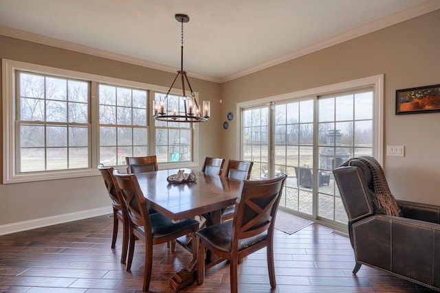 dining area with dark wood-style floors, baseboards, ornamental molding, and a notable chandelier