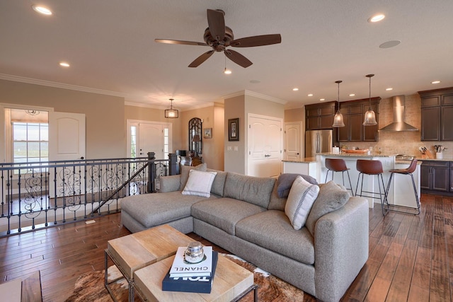 living area featuring ornamental molding, dark wood finished floors, and recessed lighting