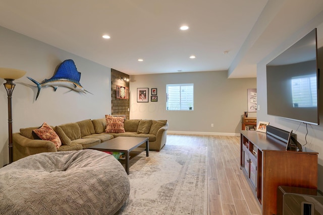living area with recessed lighting, baseboards, and light wood finished floors