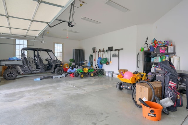garage featuring freestanding refrigerator and a garage door opener