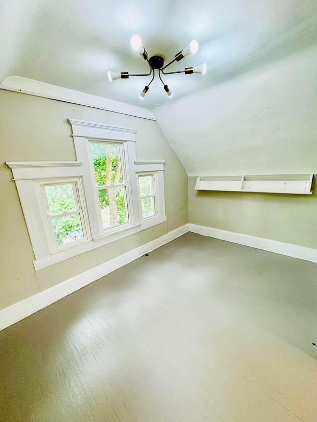 bonus room with vaulted ceiling, wood finished floors, and baseboards