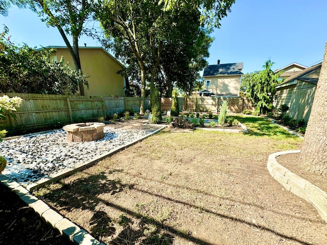 view of yard with an outdoor fire pit and a fenced backyard