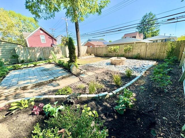 view of yard with an outdoor fire pit, a patio area, and a fenced backyard