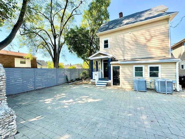 back of house with a patio area, fence, and cooling unit