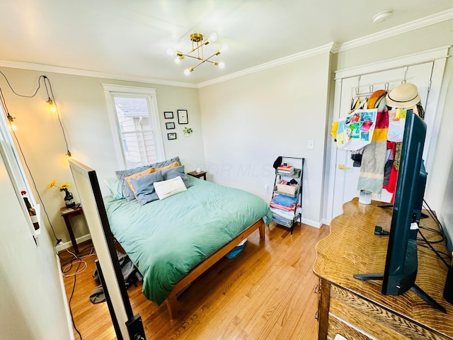 bedroom with baseboards, ornamental molding, light wood-type flooring, and a notable chandelier