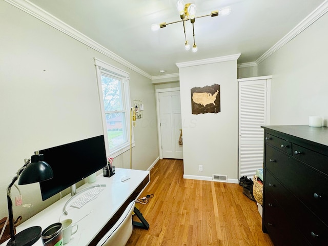 office space with baseboards, ornamental molding, visible vents, and light wood-style floors