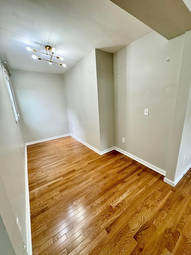 spare room with wood finished floors and baseboards