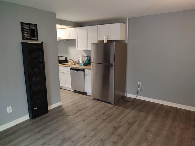74 W Moler St, Columbus, OH 43207 - kitchen featuring stainless steel appliances, white cabinetry, baseboards, and wood finished floors