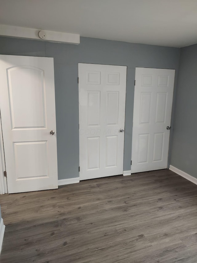 74 W Moler St, Columbus, OH 43207 - unfurnished bedroom featuring dark wood-style flooring and baseboards