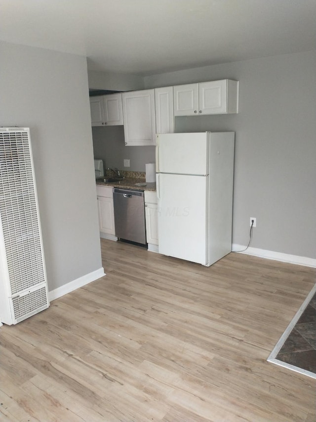 74 W Moler St, Columbus, OH 43207 - kitchen with freestanding refrigerator, white cabinets, a heating unit, a sink, and dishwasher