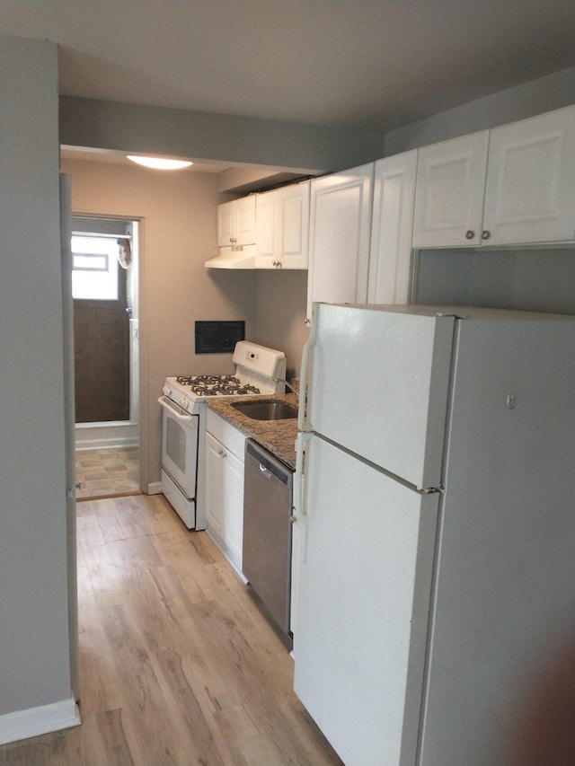 74 W Moler St, Columbus, OH 43207 - kitchen featuring white appliances, light wood finished floors, baseboards, under cabinet range hood, and white cabinetry