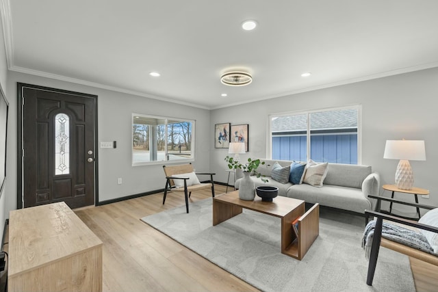 living room with light wood-type flooring, crown molding, baseboards, and recessed lighting