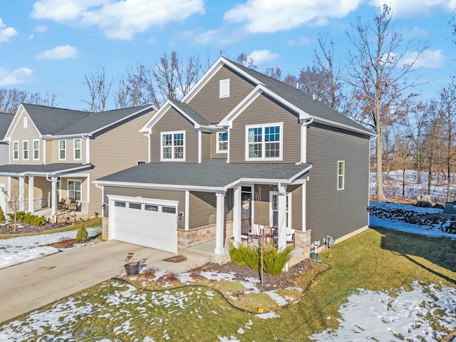 view of front of home featuring a porch, a shingled roof, an attached garage, stone siding, and driveway