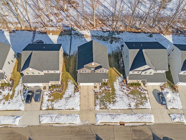 snowy aerial view featuring a residential view