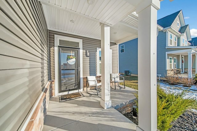 view of exterior entry featuring covered porch