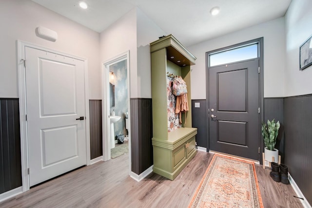 mudroom featuring a wainscoted wall, recessed lighting, and light wood-style floors