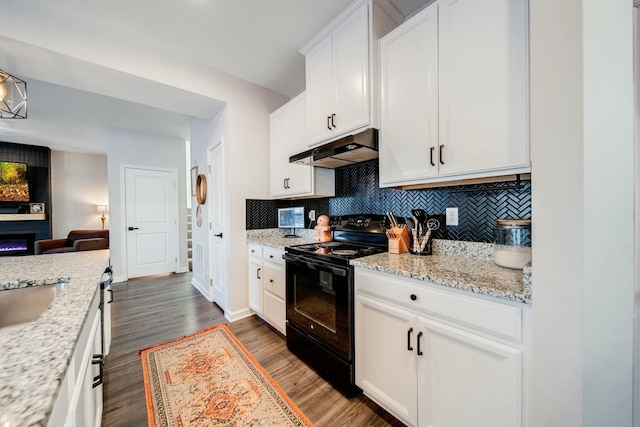 kitchen with dark wood-style floors, black range with electric stovetop, backsplash, white cabinets, and under cabinet range hood