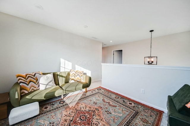 living room with carpet floors, baseboards, and an inviting chandelier