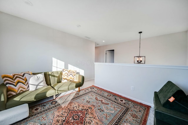 living room featuring baseboards and a notable chandelier