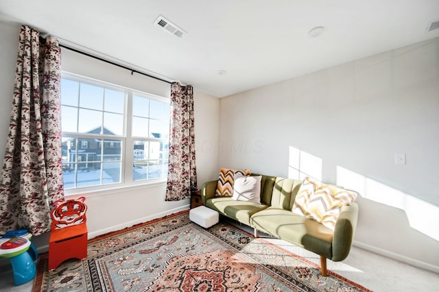 living room with baseboards and visible vents