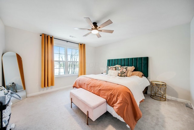 carpeted bedroom with baseboards, visible vents, and ceiling fan