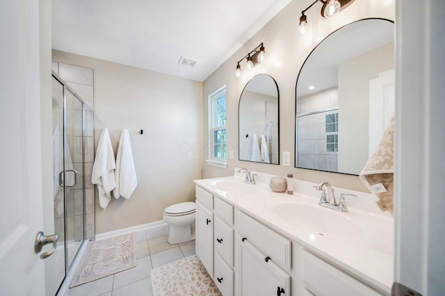 full bathroom featuring baseboards, tile patterned flooring, a sink, and a shower stall