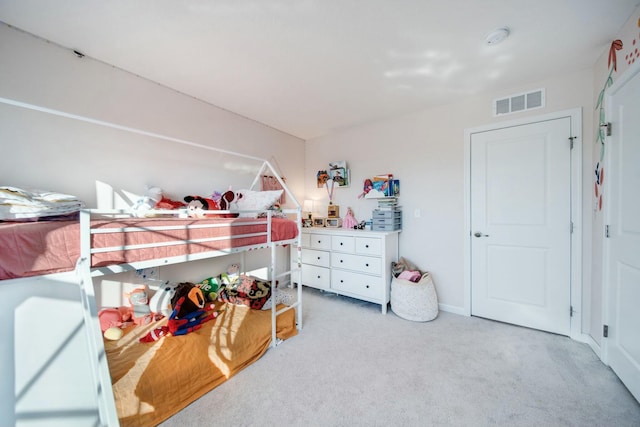 bedroom featuring visible vents and light carpet