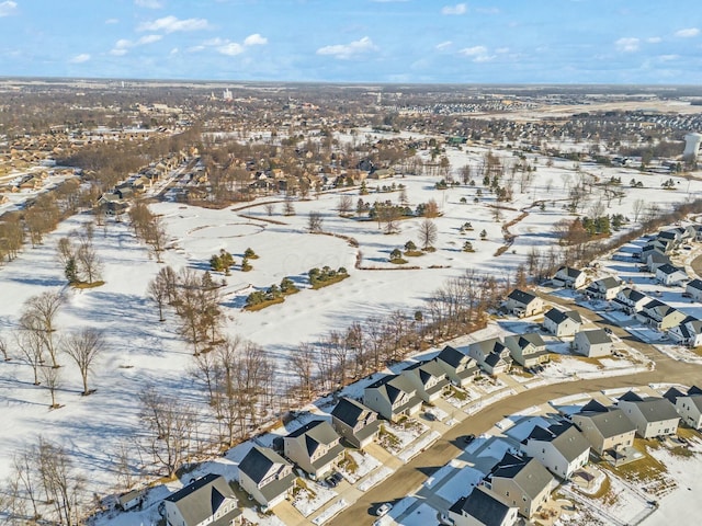 snowy aerial view with a residential view