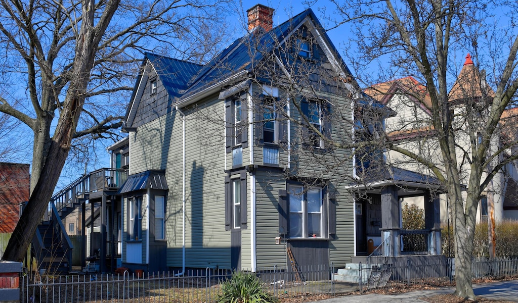 view of front of property with a fenced front yard and a chimney