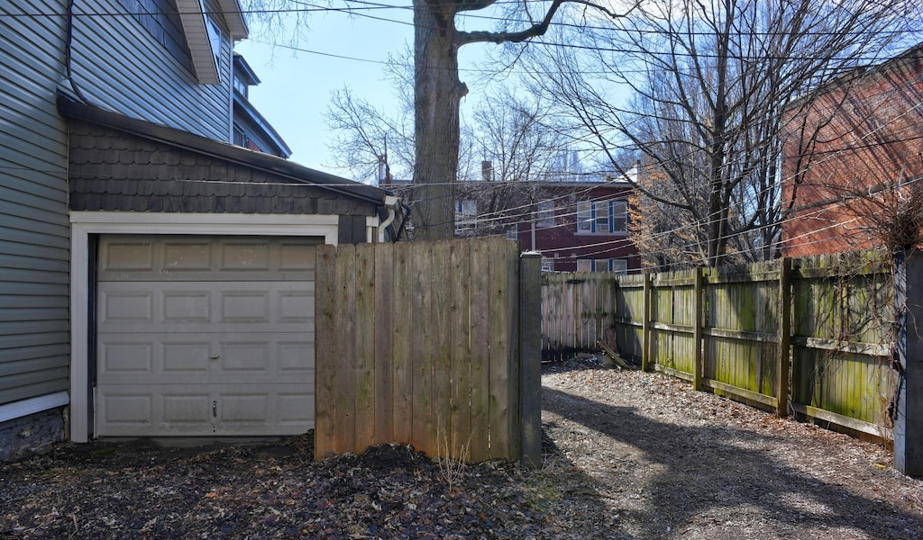 view of yard with a garage and fence