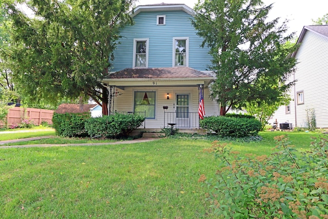 view of front of home featuring covered porch, central AC, a front lawn, and fence