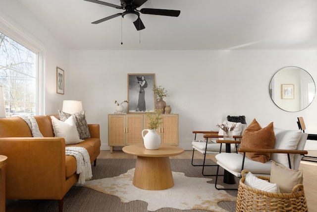 living area with ceiling fan and wood finished floors