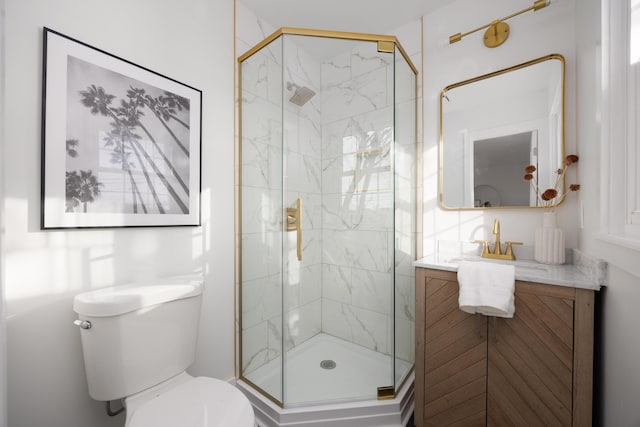 bathroom featuring toilet, a shower stall, and vanity