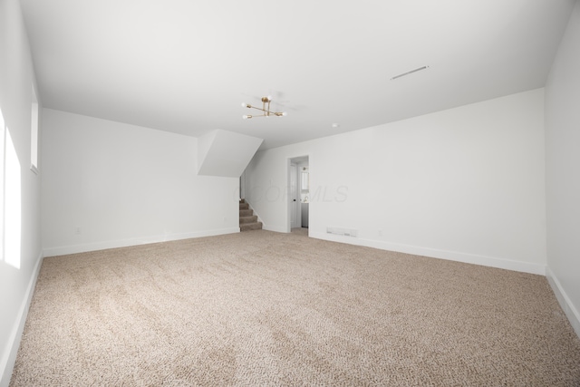 additional living space featuring stairs, carpet flooring, and baseboards