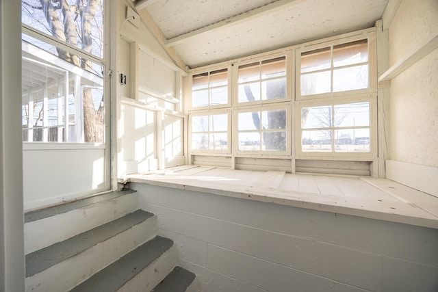 unfurnished sunroom with vaulted ceiling