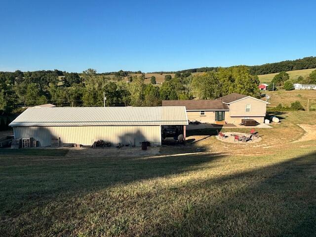 exterior space with an outdoor structure, a lawn, and an outbuilding