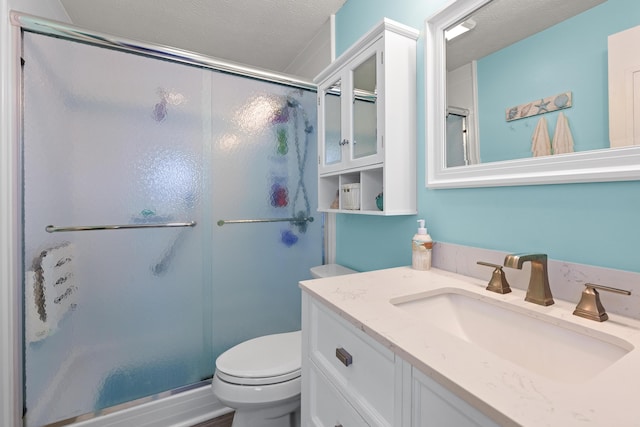 full bathroom with a stall shower, a textured ceiling, and toilet