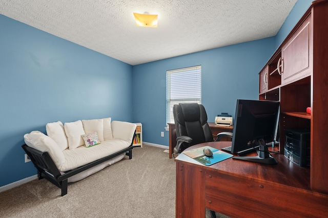 office featuring baseboards, a textured ceiling, and light colored carpet