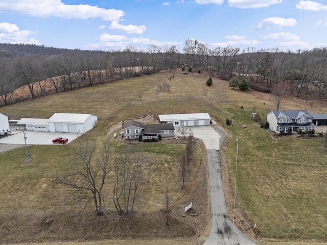 drone / aerial view featuring a rural view and a view of trees