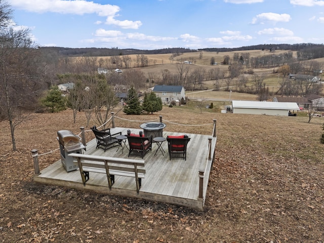 view of yard featuring a rural view, a wooden deck, and an outdoor hangout area