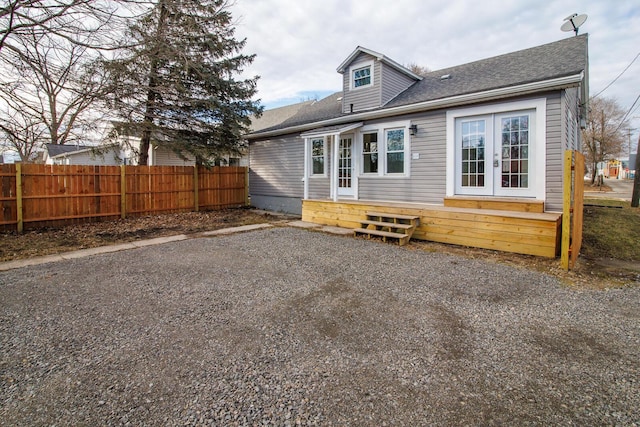 back of house with entry steps, french doors, and fence