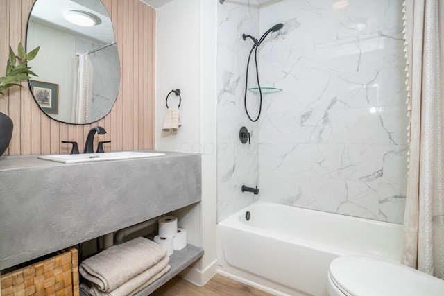 full bath featuring shower / tub combo, vanity, toilet, and wood finished floors