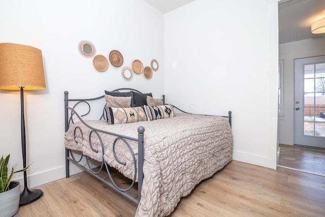 bedroom with wood finished floors and baseboards