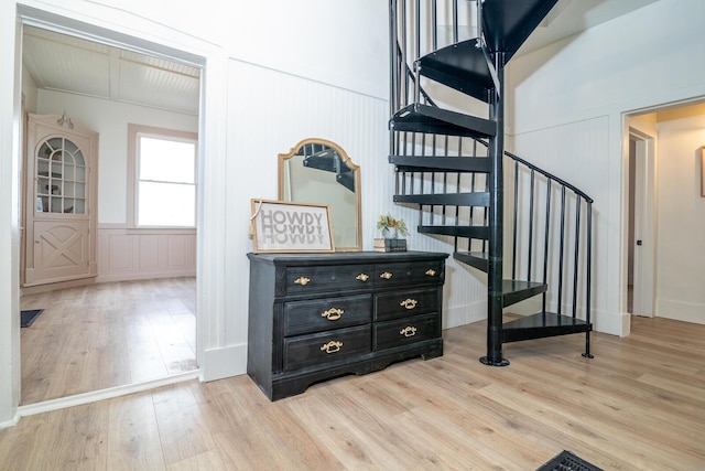 staircase with visible vents and wood finished floors